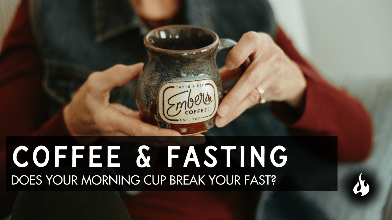 Hands holding Ember Coffee mug with text about coffee and fasting