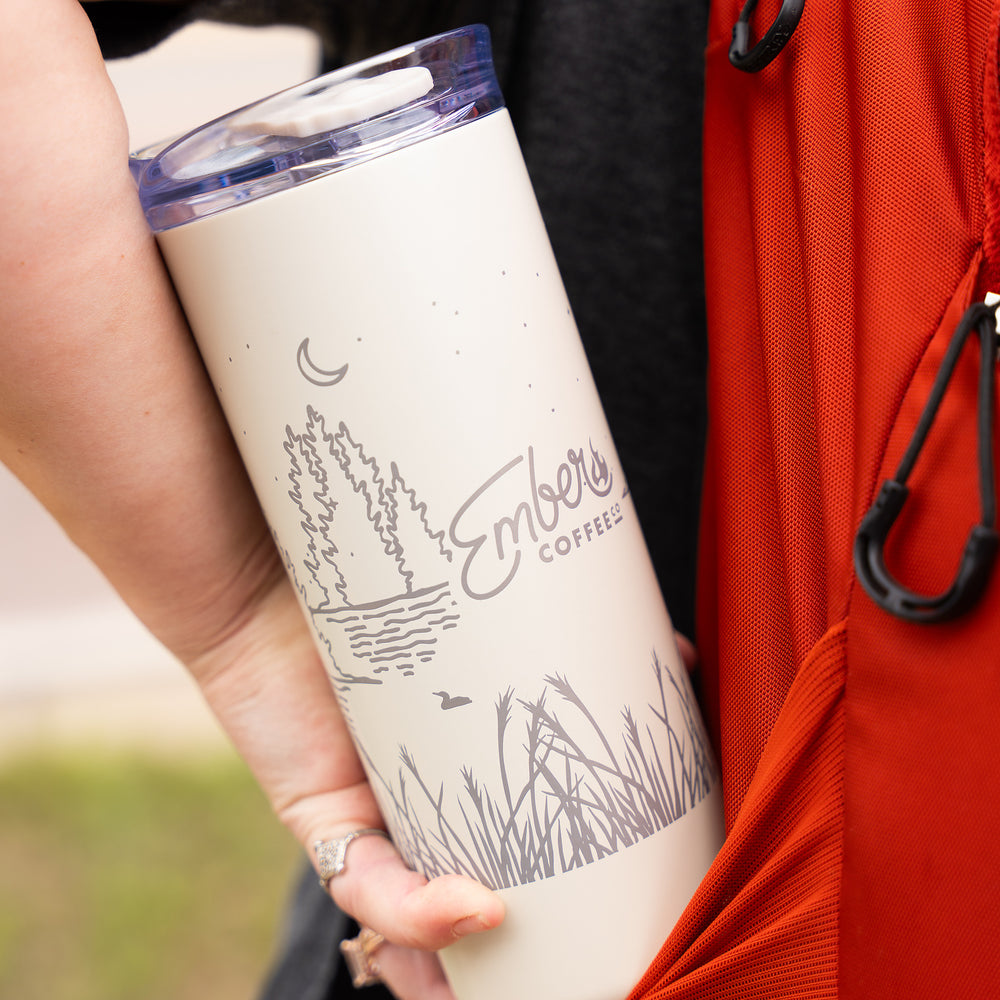 Ember Style Petal Tumbler carried at the side of an orange daypack