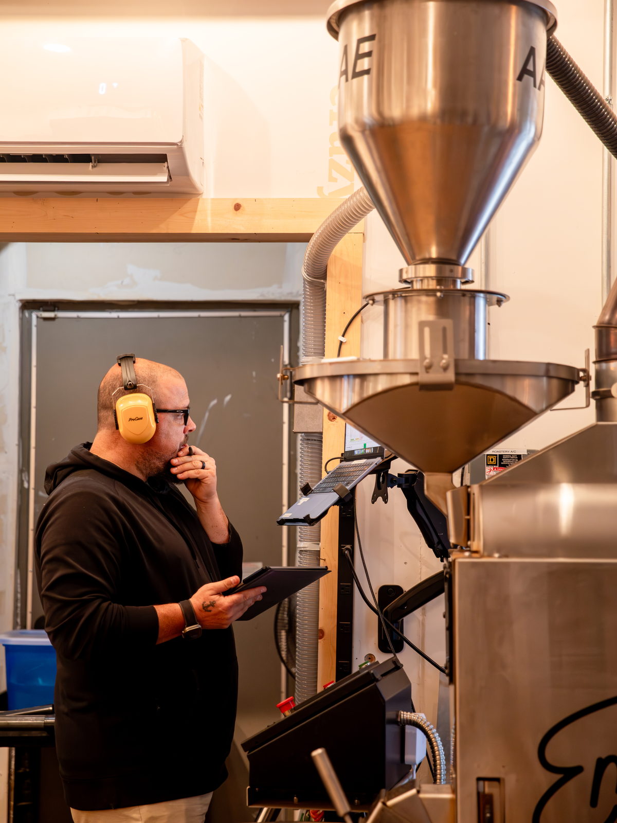 Coffee roaster working beside a vintage scale