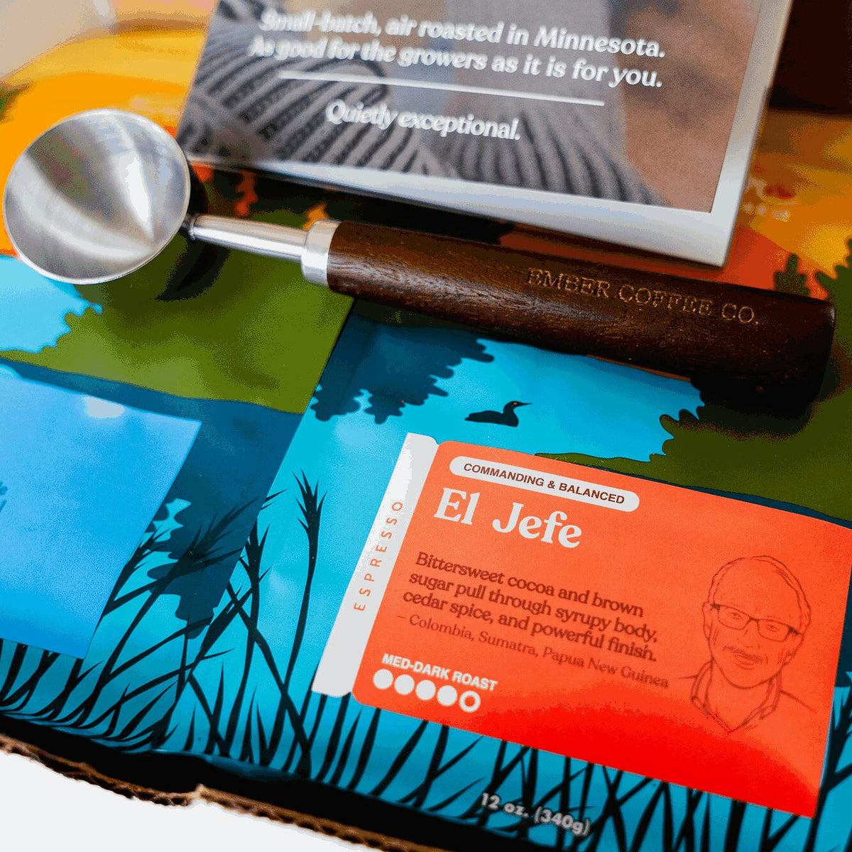 Close-up of El Jefe espresso bag and Ember Coffee Co. engraved walnut scoop