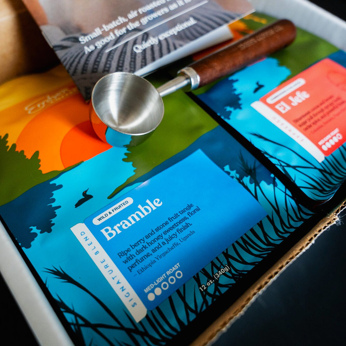 Close-up of Bramble signature blend bag with stainless coffee scoop