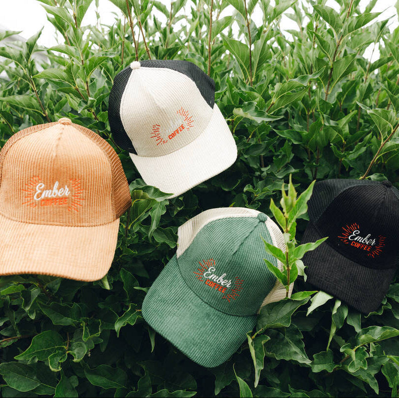 Baseball Hat, Ember Coffee corduroy caps in Black, Green, Cream and Brown, on greenery