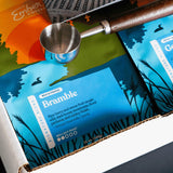Close-up of Bramble signature blend bag with stainless coffee scoop in the Light Roast Kit