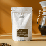 Toasted Southern Pecan 4 oz sample bag beside a Chemex of brewed coffee
